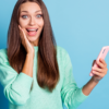 mulher feliz com o celular na mão
