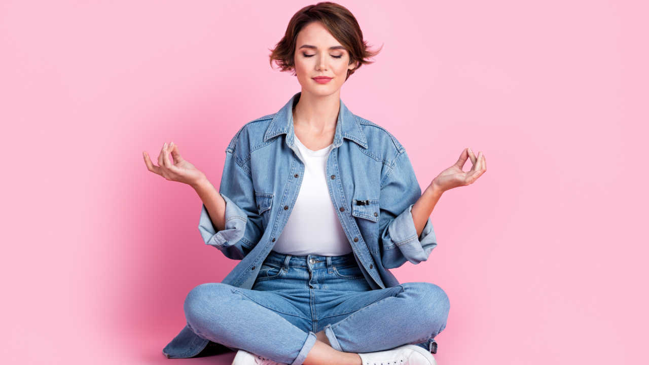mulher meditando em fundo rosa