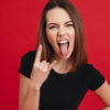 Retrato de uma garota rebelde, isolada sobre um fundo vermelho.