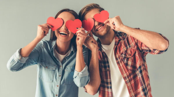 homem e mulher sorrindo com um coração nos olhos