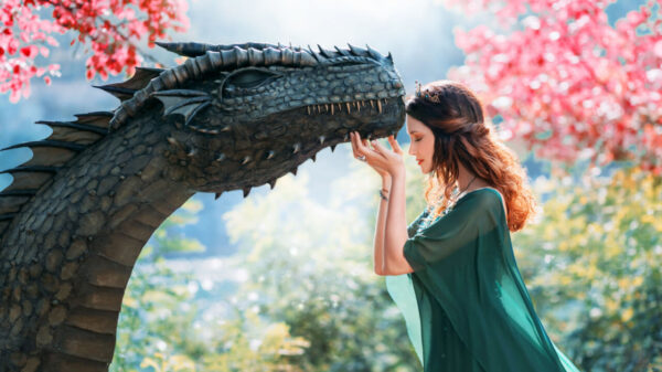 imagem de fantasia onde uma princesa de vestido verde toca no queixo de um dragão